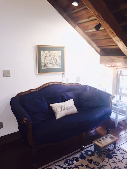 Settee with footstool and ample light in the room.