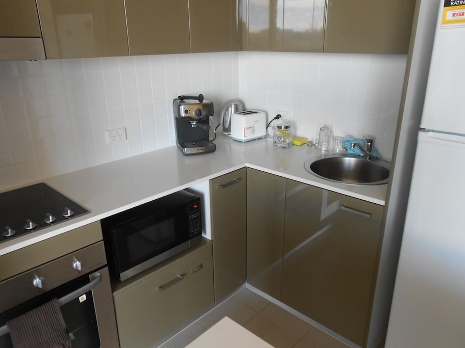 full kitchen with dishwasher, expresso machine, even potato masher etc