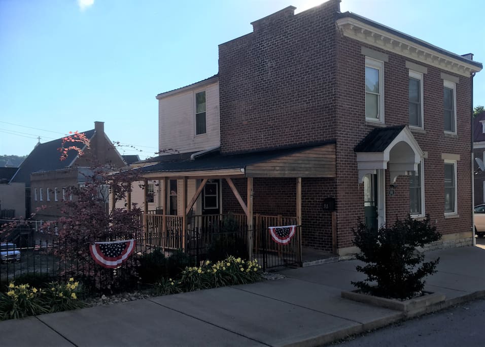Side porch with table and several chairs to enjoy a morning cup of coffee or an afternoon adult beverage.