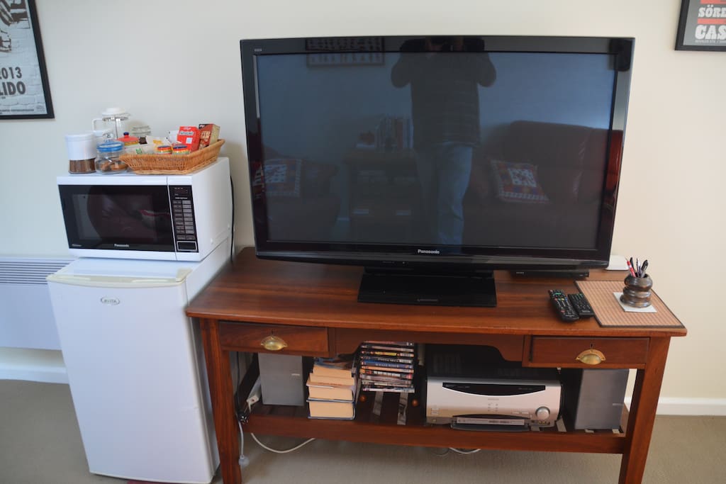 50 inch TV, DVD player (with a selection of DVD's), Stereo Receiver, Apple AirPlay, Unlimited Wi-Fi, books and games, even jigsaw puzzles.