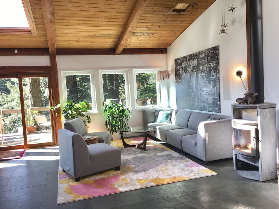 Open floor plan includes vaulted wood-beam ceiling, slate tile foors, five skylights, wood stove, and lots of windows!