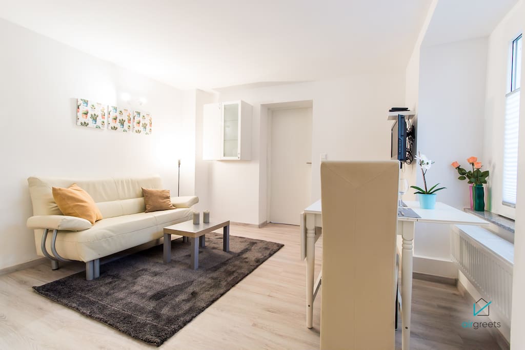 The living room is perfect for relaxing and enjoying food.
