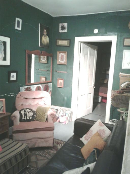 View of the current arrangement of the Living Room / Seating area where the couch is located. This room also has a record player and is connected to both the bedrooms as well as the adjoining art studio.