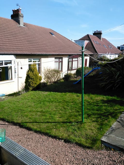 Mature back garden with decking area and lawn. South facing.