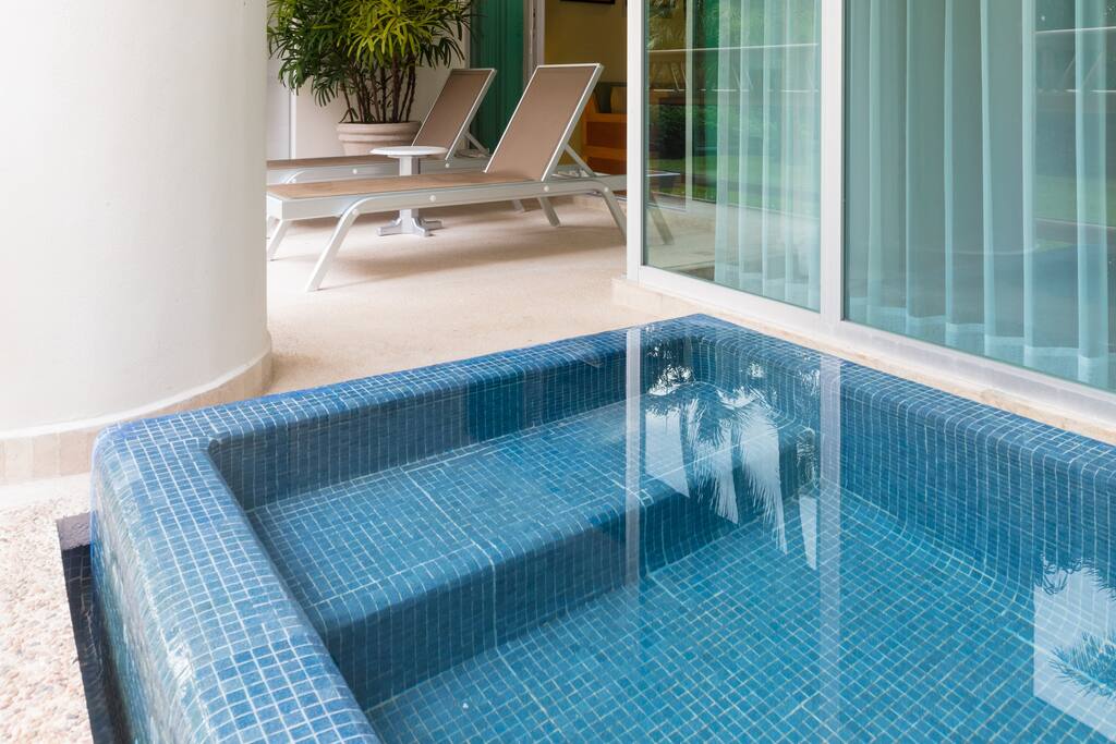 A balcony with private plunge pool and views of the beach and jungle.