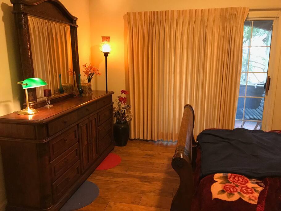 Country queen bedroom with refrigerator, private restroom, and jacuzzi on balcony.