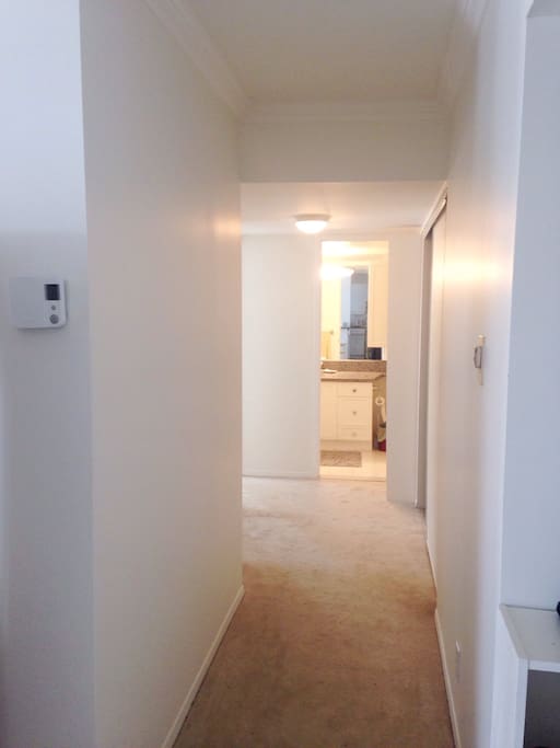 hallway leading to both bedrooms and bathroom