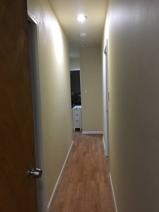 3rd floor hallway. Blue room is 1st door on right. Ahead are mini-kitchen, green room, and bathroom.