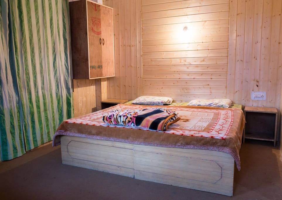Cozy room with big double bed and pinewood finish