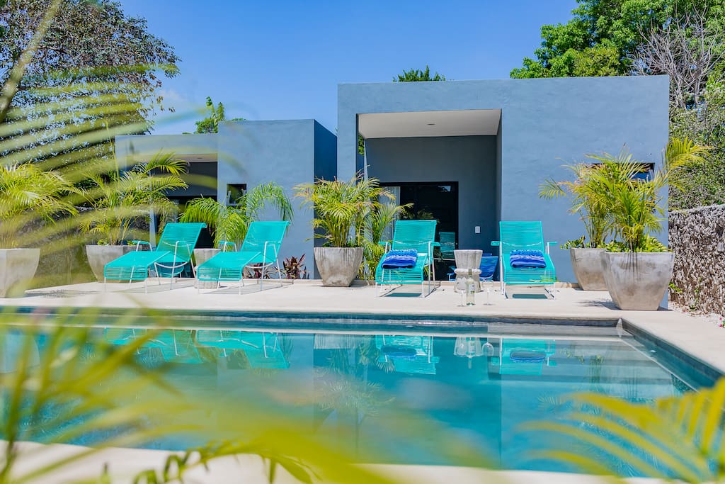 Both casitas are in the back garden with the pool infant of them.