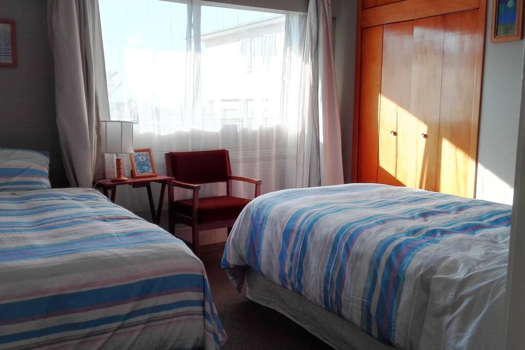Second bedroom with a king single and single beds.