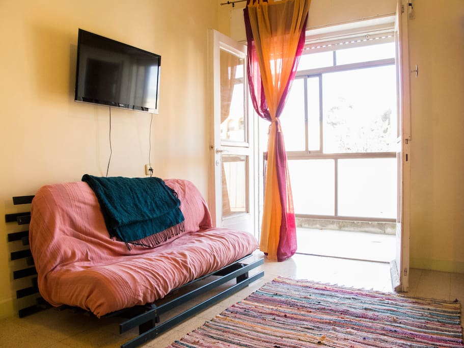 Living room, TV, and futon, can accommodate 2.