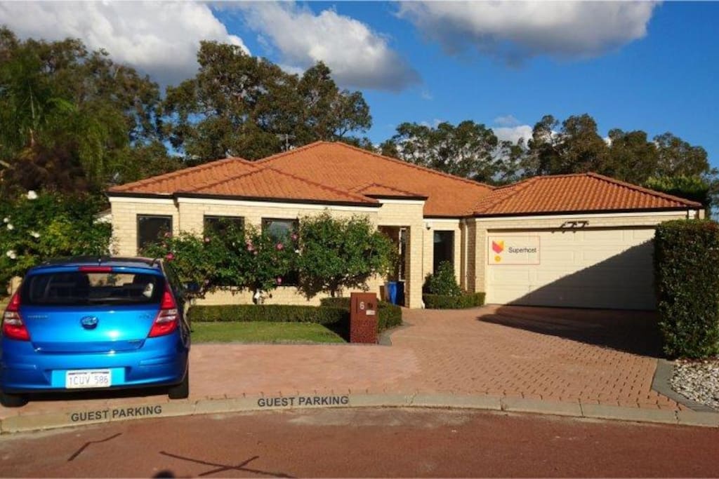 Front view of the house, note guest parking.
