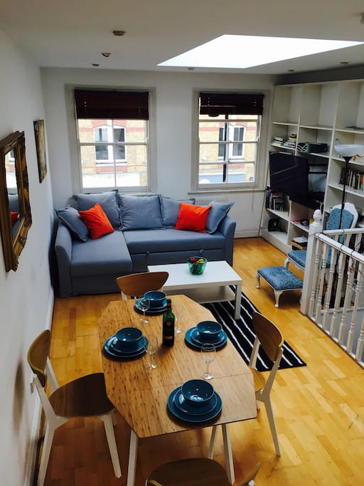 View from roof terrace steps down to living and dining area. Corner sofa converts to a double bed. Huge TV with all the usual channels.