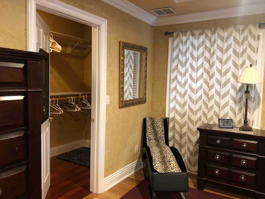 Huge walk in closet, chaise longue, night stand and reading lamp