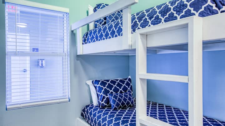 Bunk room. The open blinds show how close the stairs and trash chute is to the condo...