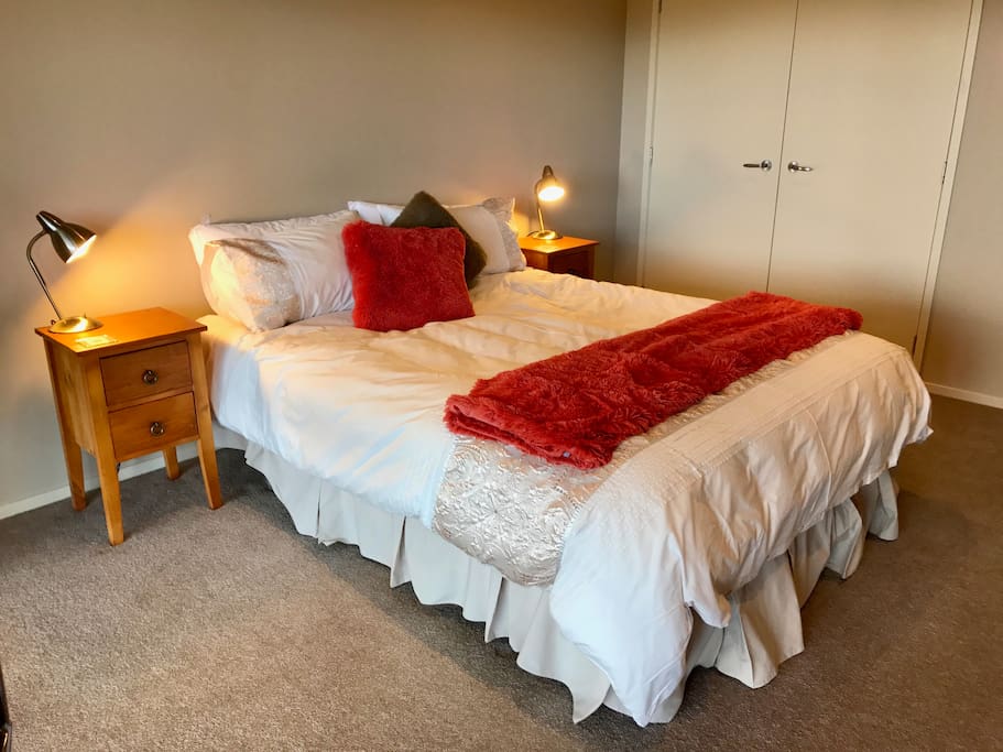 Spacious main bedroom with queen bed, built in robe and large chest of drawers