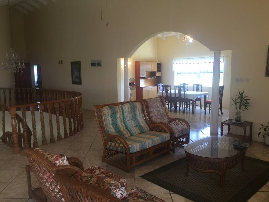 Living room with dining room, staircase in background