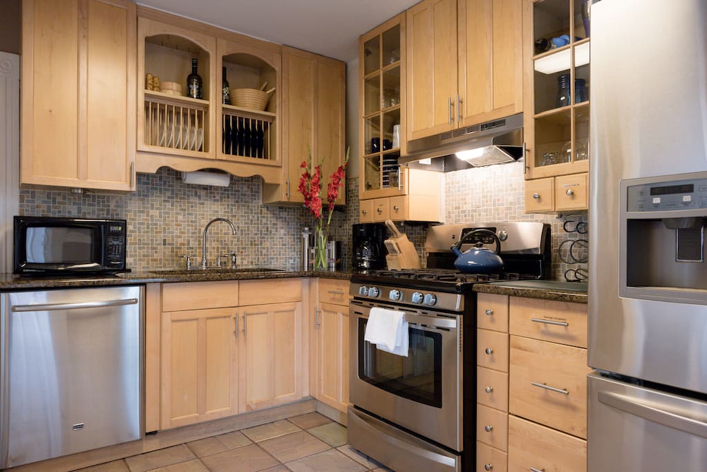 Updated kitchen with granite countertops, stainless steel appliances, complete dishware, cooking supplies and stocked coffee station.