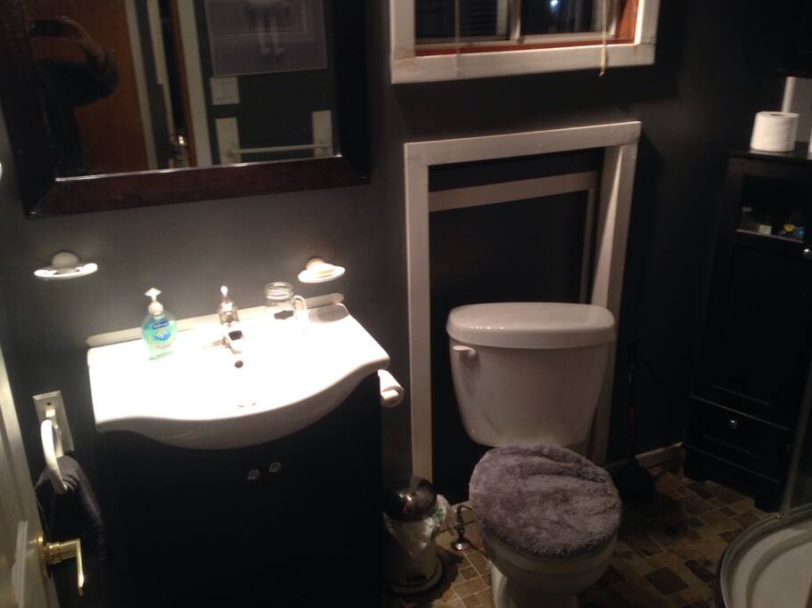 Private bathroom for guests on main floor upon entering house through garage