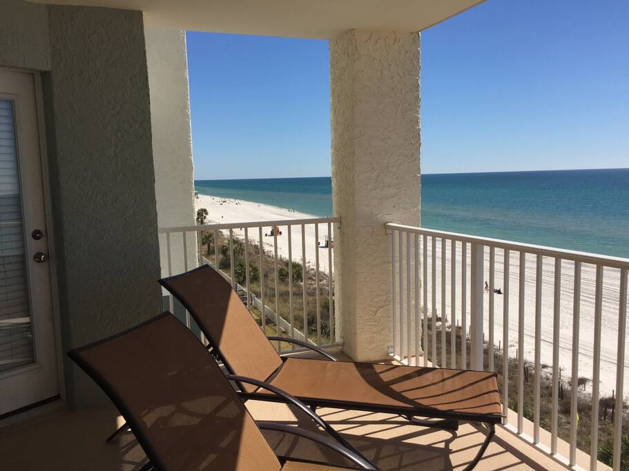 Extra-wide balcony with several chaise lounge chairs