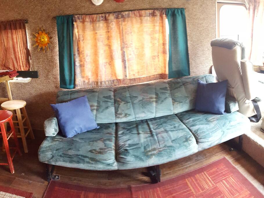 Cozy couch that folds out to full size bed (on the smaller side.)