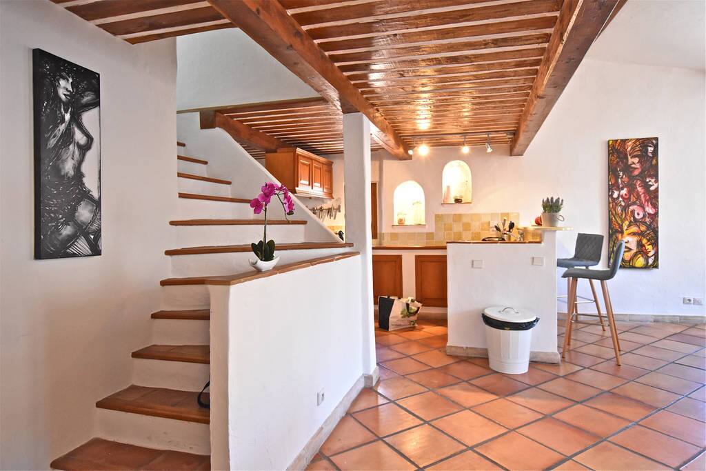 View of the kitchen. part of the dining-room and staircase to the first floor