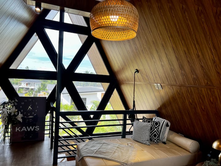 Loft style room with 1 sofa bed and queen bed.