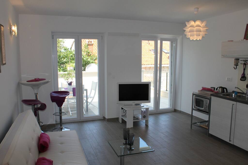 Modern lounge/kitchen area with sat TV