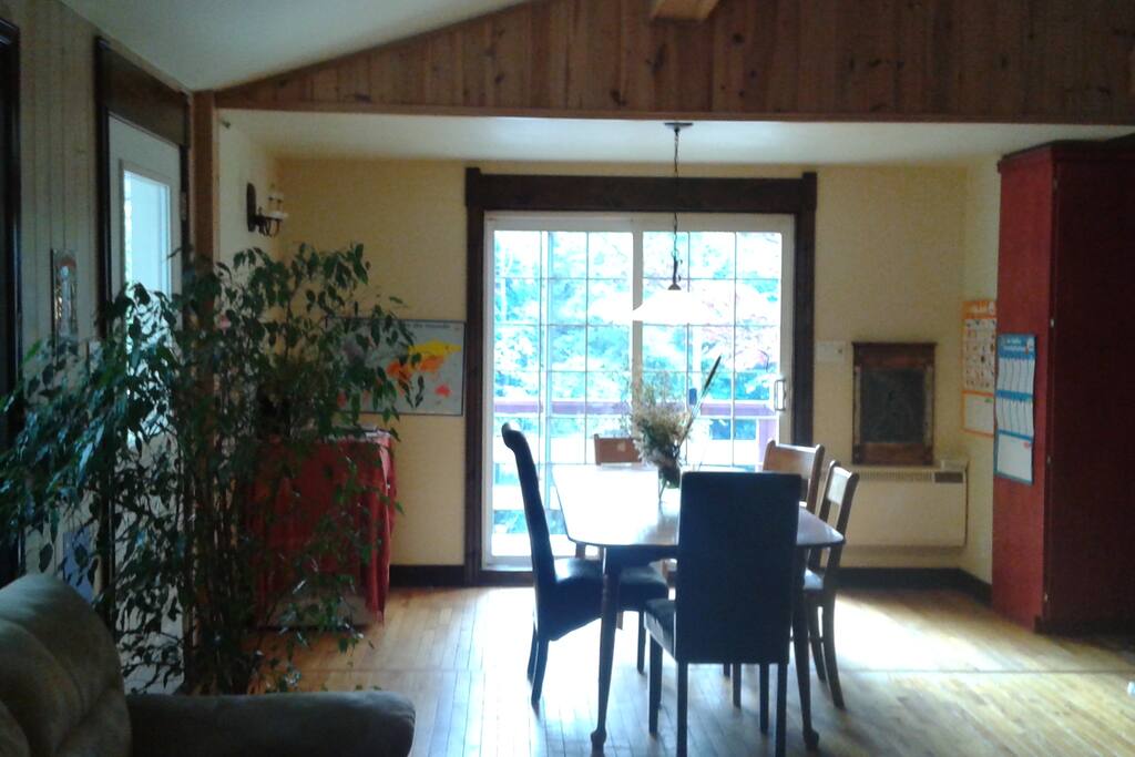 The sunny dining room has a nice view on the forest
