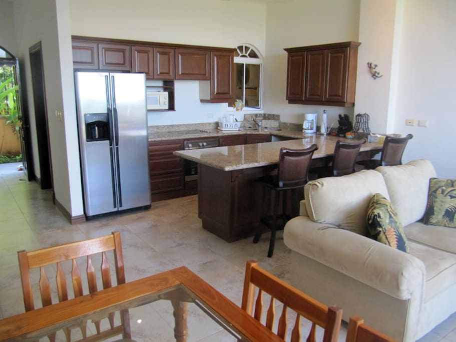 Kitchen, bar area and living room