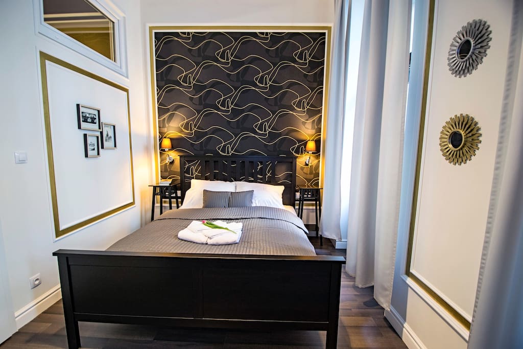 the first cozy bedroom with double bed and wardrobe