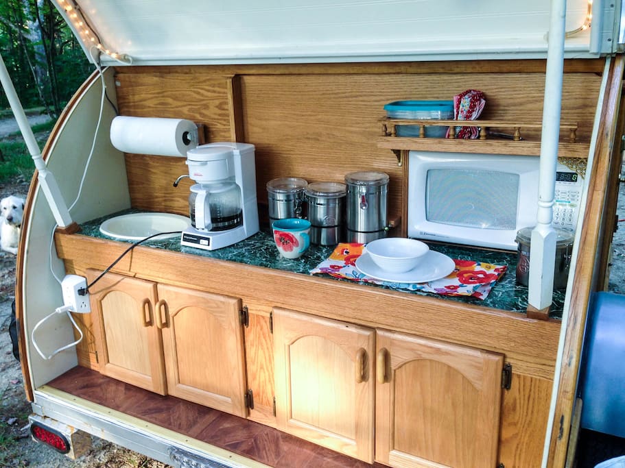 The kitchen has a sink, a microwave and a coffee maker. A coleman stove is also available. The kitchen is well-lit by LED rope lighting. Very pretty at night!