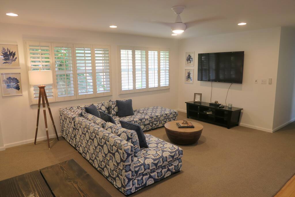 Living room with large couch and entertainment facilities