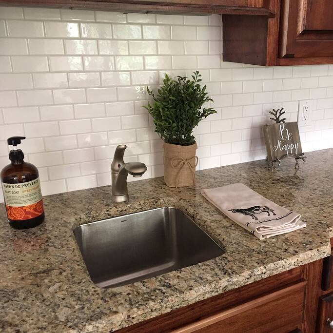 Kitchen includes a mini fridge, sink, keurig, cups, snacks..