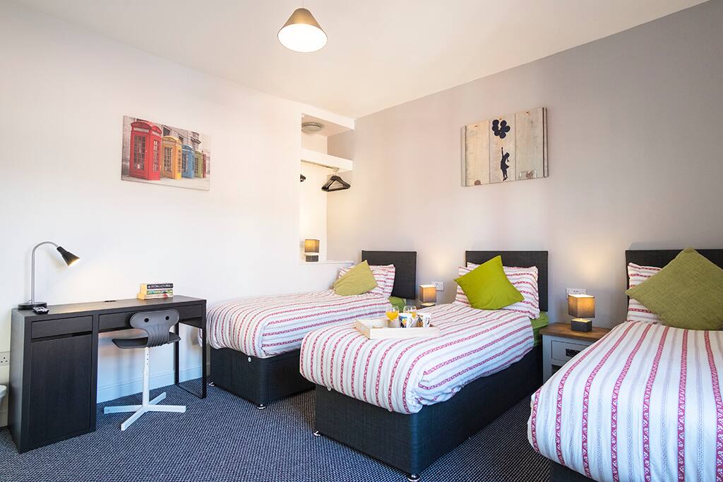 Master Bedroom with workspace, can be set up with 1 double bed and 1 single, or 3 single beds.