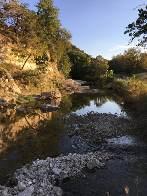Creek and cliffs at sunset
