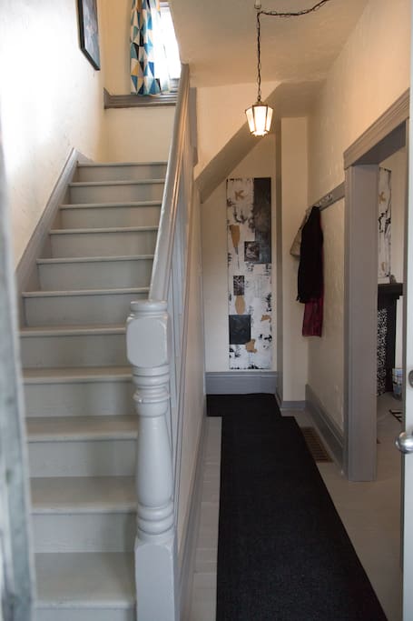 As soon as you walk in from the front veranda you can access the stairs up to the bedroom and bathroom or hang your coat in the hallway.