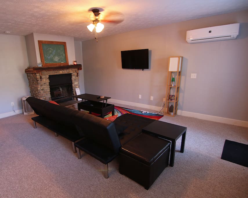 Living room has lift-top coffee table, two futon couches, flat screen smart tv equipped with WiFi.