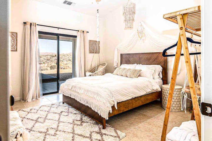 Master bedroom with a view of the backyard and en-suite