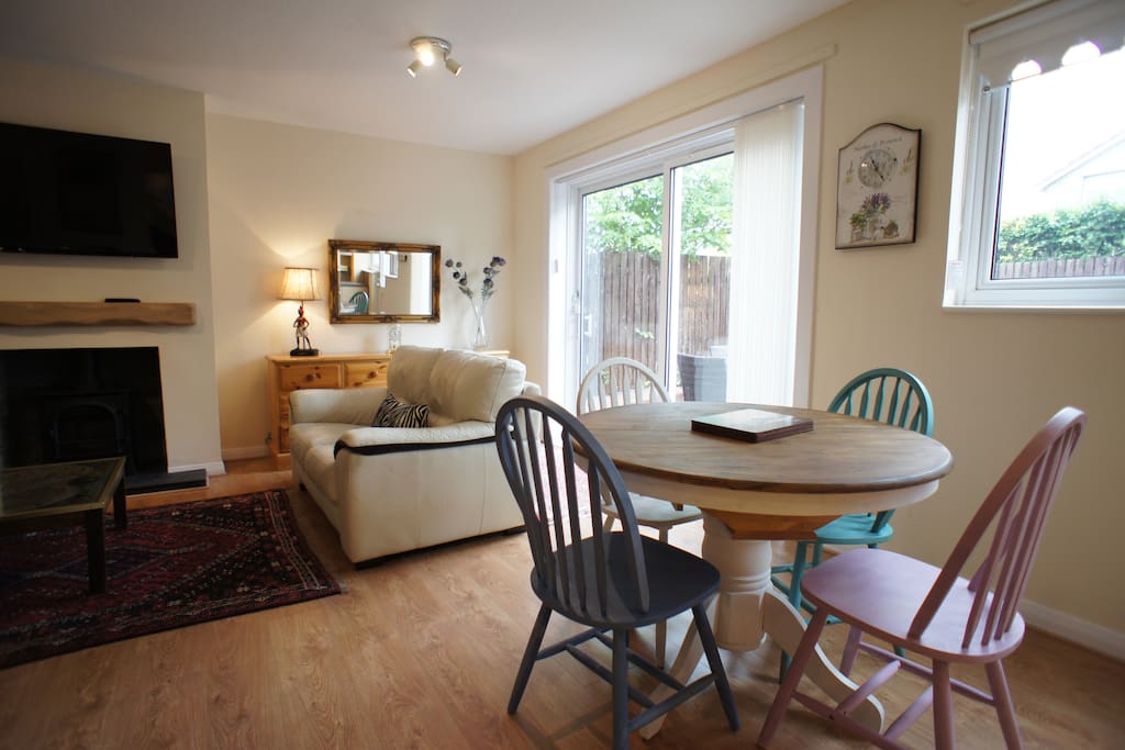 Open plan living room and kitchen with dining for four