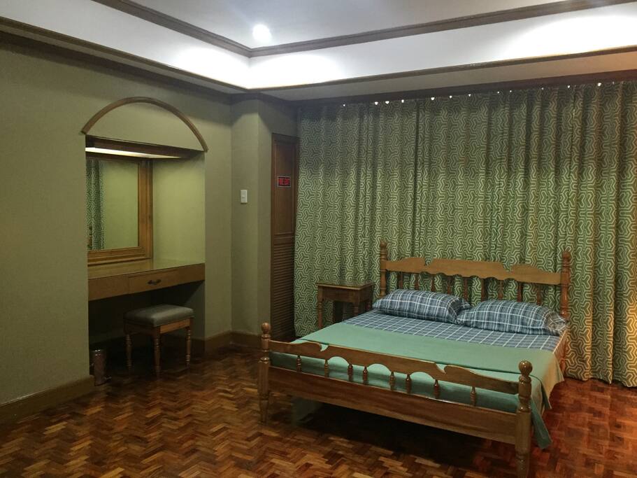 Master’s bedroom with table dresser. Note the fire escape door on the right side of the dresser.