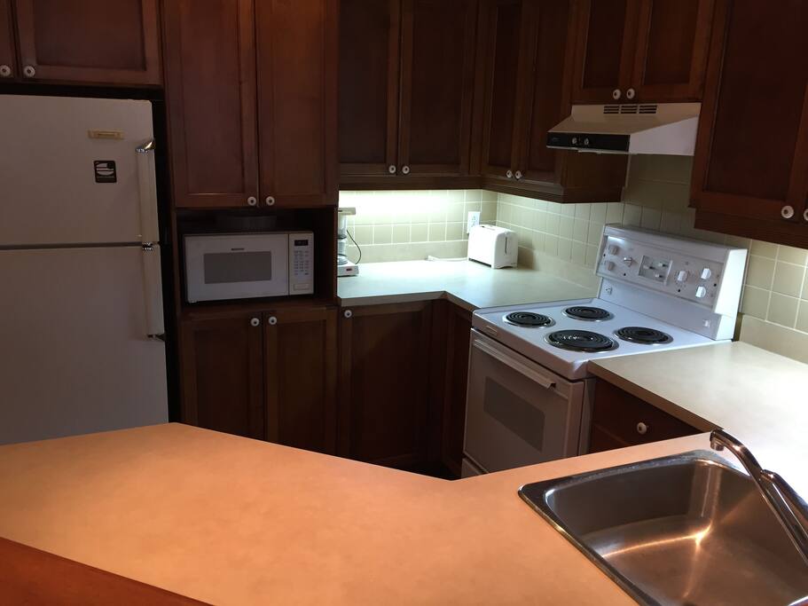 Comfortable stocked kitchen complete for pots, pans dishes, microwave kettle and more