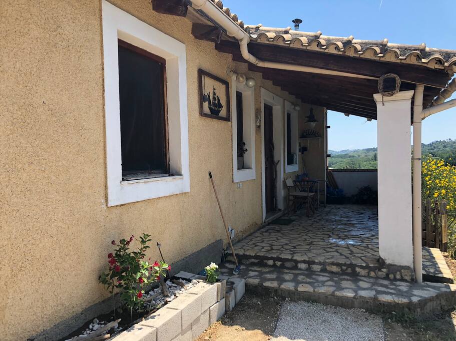 The front porch and entrance to the house. On the right is a fish pond with KOI fishes