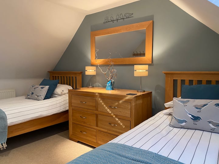 Upstairs twin bedroom is bright and airy with skylights.