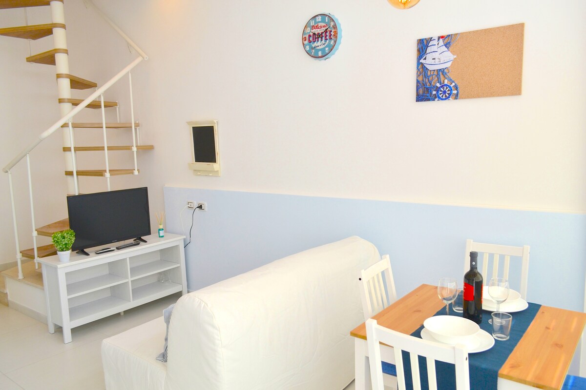 soggiorno con cucina attrezzata e angolo TV