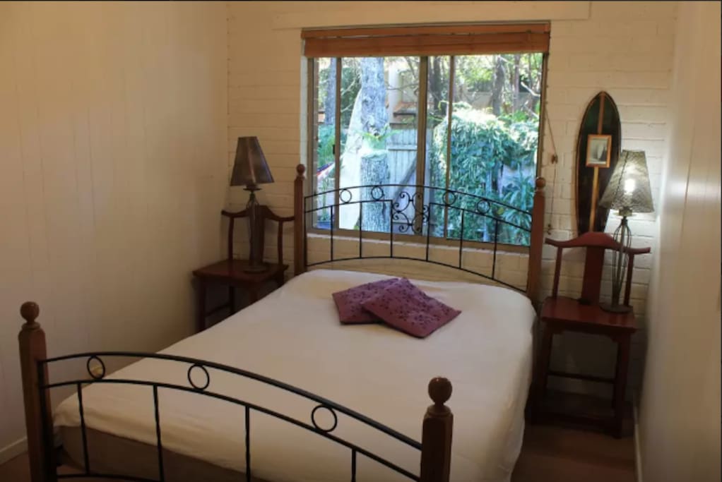 Guest room with queen bed and closet.