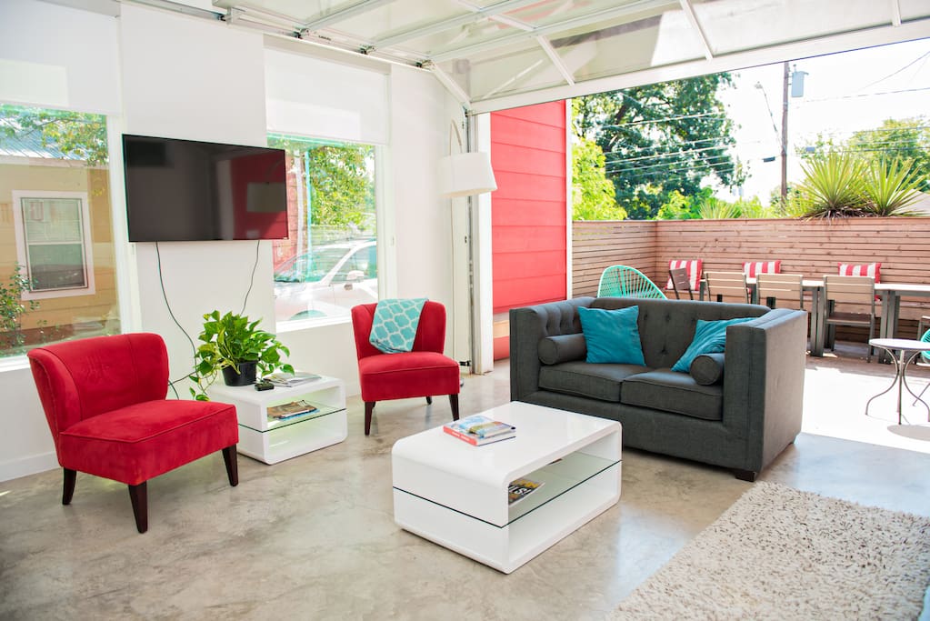 Spacious living room and kitchen opens completely to a partially covered and private patio