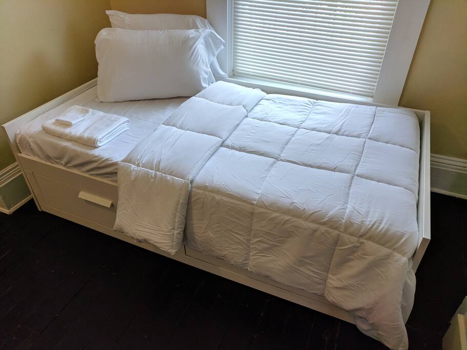 Close up of twin daybed. All sheets and linen will be bright white upon your arrival.