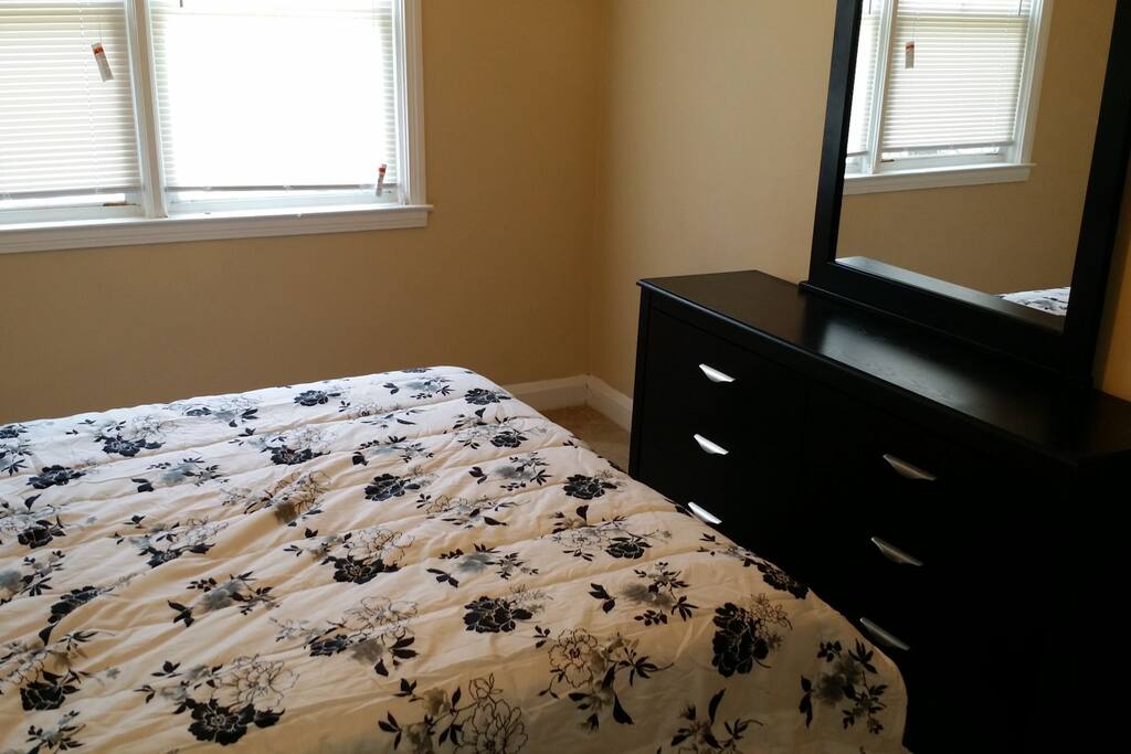 Dresser with mirror for additional clothing storage.